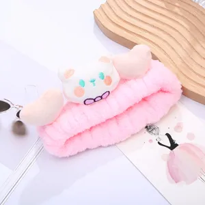 Cute pink plush cat makeup headband, soft fluffy hair hoop for facial washing and spa skincare.