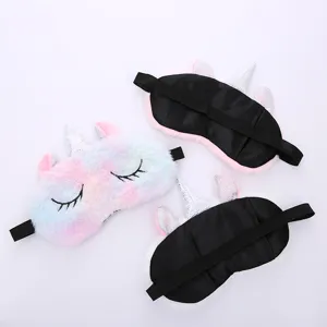 Plush unicorn sleep mask detail featuring soft rainbow faux fur, silver horn and back strap.