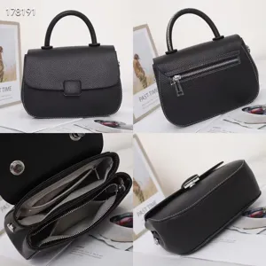 Detailed view of black leather handbag featuring top handle, zipper pocket, and interior compartments.