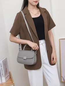 Grey leather top handle crossbody bag for women, stylish flap purse with metal hardware.