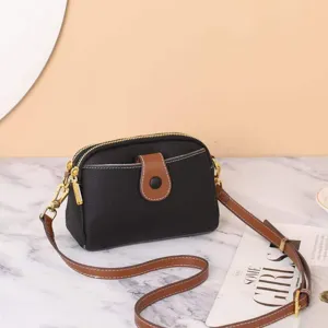 Detailed view of genuine leather crossbody bag with flap and metal hardware for women.