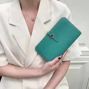 Green leather long wallet and passport holder with metal ring closure for travel use.