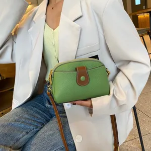 Green genuine leather crossbody bag for women, stylish small shoulder bag with brown buckle.
