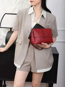 Genuine leather crossbody bag detail shot, stylish red shoulder bag for women daily wear.