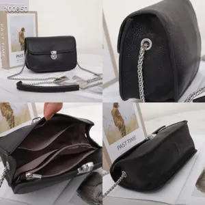 Black genuine leather shoulder bag detail, showing metal lock, chain strap and multi compartments.