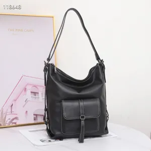 Sac à dos en cuir véritable pour femme, élégant sac porté épaule noir avec poche avant.