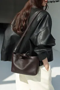 Minimalist genuine leather shoulder bag for women, large capacity casual commuting handbag.