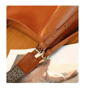 Genuine leather women crossbody bag detail, vintage brown cowhide shoulder bag strap hardware.
