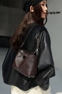 Details of the genuine leather shoulder bag in dark brown, featuring a stylish hobo bucket design.