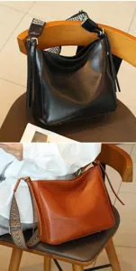 Vintage genuine leather shoulder bag for women, classic minimalist crossbody purse with wide strap.