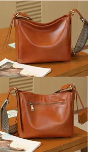 Genuine leather women's shoulder bag with wide strap, retro minimalist design, brown.