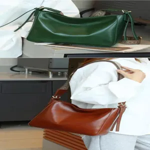 Leather shoulder bag for women, vintage hobo crossbody bag with wide strap and tassel details.