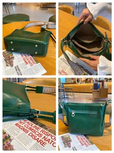 Dark green genuine leather shoulder bag detail showing interior compartments and metal feet.