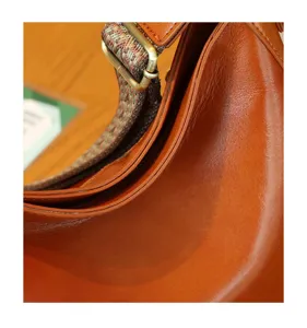 Premium genuine leather shoulder bag, classic retro crossbody design with chic strap detail.