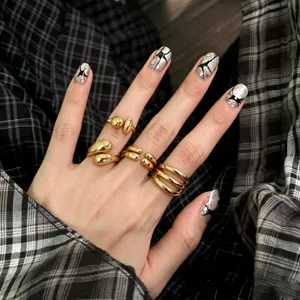 Close-up shot of trendy gold geometric rings set on a hand, showcasing unique minimal style.