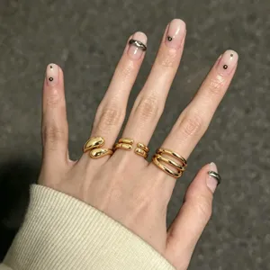 Detailed view of trendy minimalist metal ring set, exquisite fashion gold finger rings.