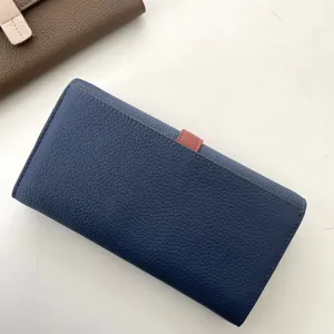 Portafoglio lungo da donna in pelle con cinturino a contrasto e tasche per carte.