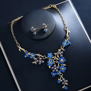 Close-up of blue rhinestone pearl flower necklace earrings set for bridal wedding party.