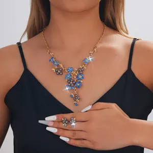 Close-up view of the exquisite blue crystal pearl floral necklace and matching earrings set.