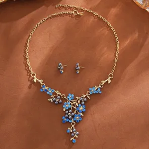 Pearl flower necklace and earrings jewelry set with blue crystals and elegant design details.