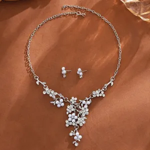 Detailed shot of the elegant pearl and rhinestone floral necklace and earrings jewelry set.