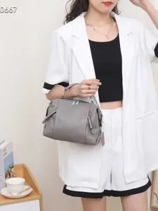 Genuine leather handbag for women, stylish grey top-handle shoulder bag with large capacity.