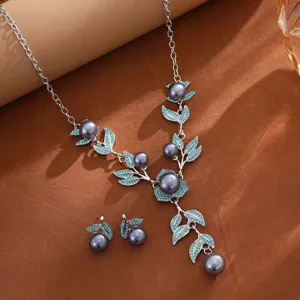 Elegante conjunto de collar y pendientes de perlas grises con hojas de cristal turquesas.