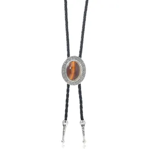 Vintage western bolo tie with black braided leather cord and retro gemstone pendant necklace.