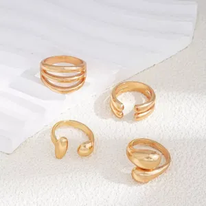 Detail shot of gold-plated metal open rings set, stylish unique design for women daily wear.