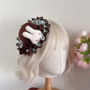 Detailed view of brown Lolita mini hat featuring plush bunny and elegant lace ruffles.