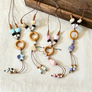 Handmade ceramic wooden bead necklace detail, vintage boho starfish shell jewelry.