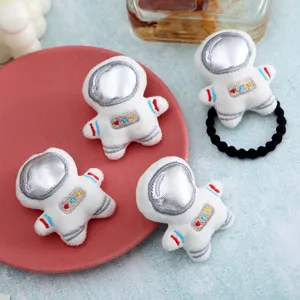 Plush astronaut hair tie detail shot, cute white fluffy space theme hair accessory decor.