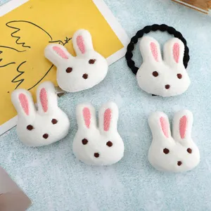 Cute plush rabbit hair clips and hair tie set, soft white material with pink embroidered ears.