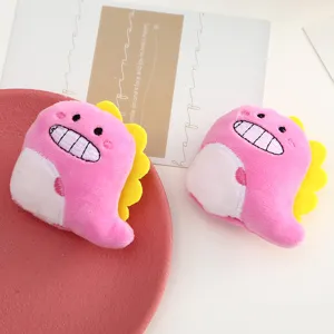 Dettaglio della spilla in peluche dinosauro rosa, materiale morbido e design carino con denti.