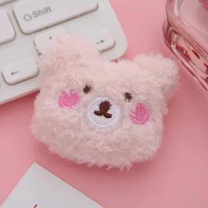 Pink plush bear brooch detail, cute embroidered cartoon design accessory for bags and clothes.