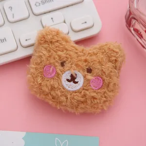 Cute plush bear brooch detail with pink blush embroidery, soft fluffy toy accessory for DIY it.