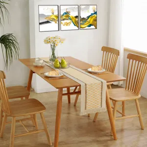 Dining table setting detail featuring a Nordic woven cotton linen fringe table runner.