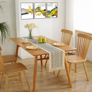 Nordic style hollow woven cotton linen table runner detail, elegant tassel fringe design.