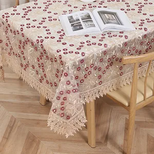 Elegante mantel de encaje bordado con motivos florales y flecos para decoración de mesa de comedor