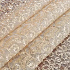 Detailed shot of exquisite French vintage embroidered round tablecloth with hollow floral pattern.