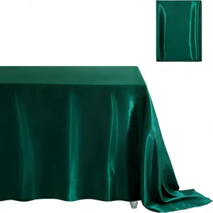 Dark green satin tablecloth detail showing smooth glossy fabric texture and elegant drape.