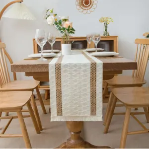 Detail shot of Nordic woven linen table runner in a cozy dining room with elegant tassel.