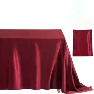 Detail view of the elegant burgundy satin rectangular tablecloth, glossy fabric for decor.
