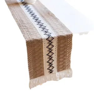 Nordic bohemian cotton linen table runner with geometric woven pattern and fringe tassels.