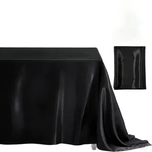 Black satin tablecloth detail showing smooth glossy fabric texture for wedding banquet decor.