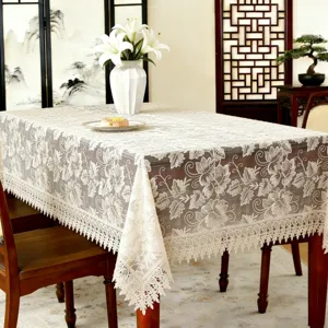 Elegant lace embroidered tablecloth detail, light coffee rectangular table cover.
