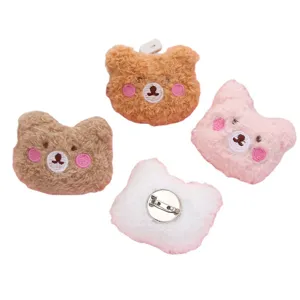 Cute plush bear brooch pin for clothing and bag decoration, soft cartoon animal accessory.