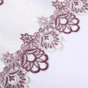 Close-up of exquisite purple and white embroidered lace tablecloth detail design element.