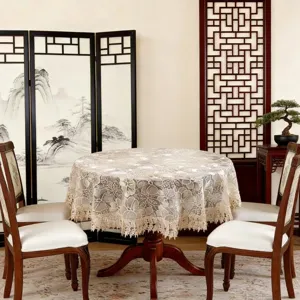Detail view of the elegant lace embroidered round tablecloth, perfect for dining room decor.