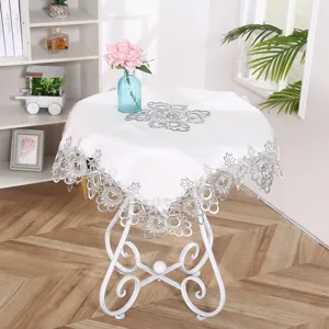 White round tablecloth with exquisite silver lace embroidery, elegant home decor scene detail.